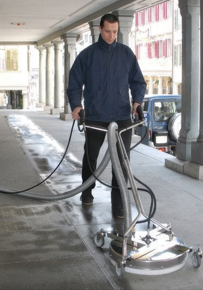 Mosmatic equipment cleaning a surface with powerful water spray.